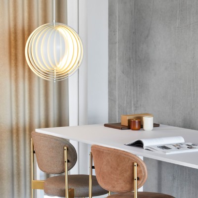 Verner Panton's iconic Moon pendant light for Verpan hangs over a corner desk next to a curtained window.