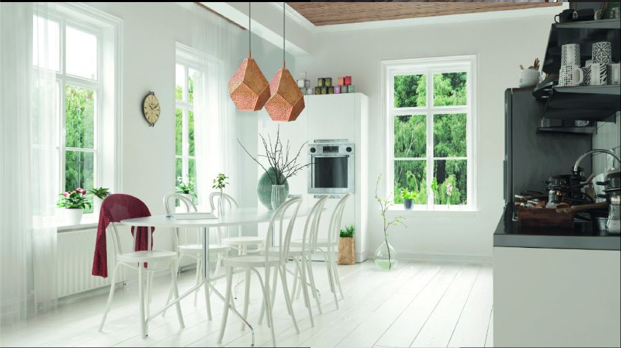 A pair of Almas pendants from designer lighting brand Dounia Home hang in a wide and spacious kitchen.