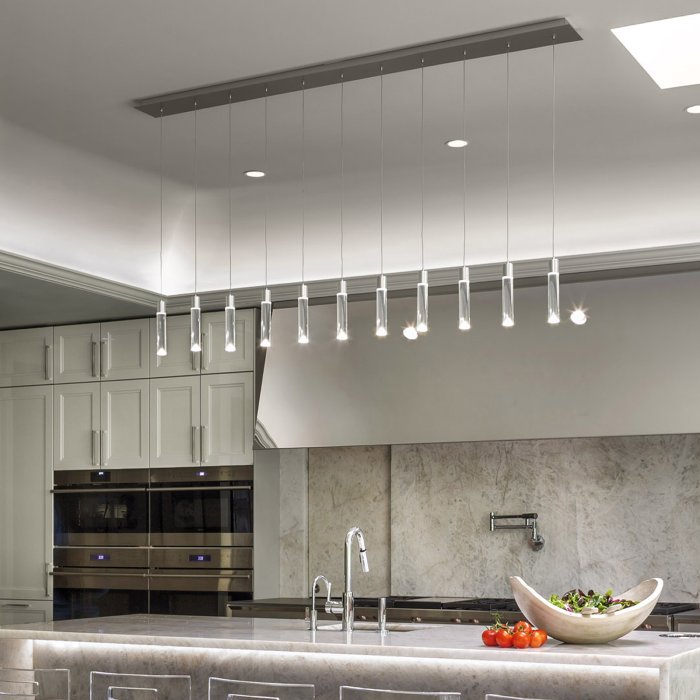 P11L linear cluster suspension light from Canadian lighting brand Archilume adds a touch of ritz to a bright contemporary kitchen.