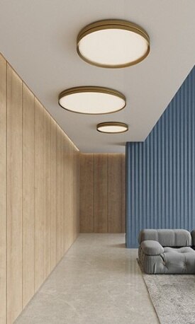 Several sizes of David Abad's Lite Hole ceiling light for B.lux throw light over a living room and hallway in an open-concept home.