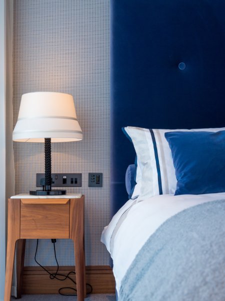 Audrey Ta Medium table lamp, designed for Contardi by Massimiliano Raggi, next to a hotel bedside.