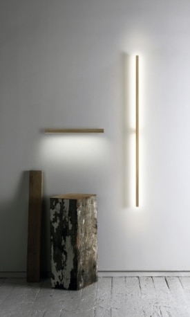 An 18 inch Ray Sconce horizontal wall light and 5 foot Ray Sconce vertical wall light from Stickbulb, along with some artistically-posed raw materials.