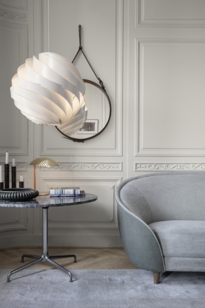 Turbo pendant light hangs in a sleek contemporary design living room.