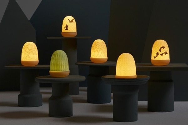 The entire Dome collection portable porcelain table lights in a dramatic mood shot.