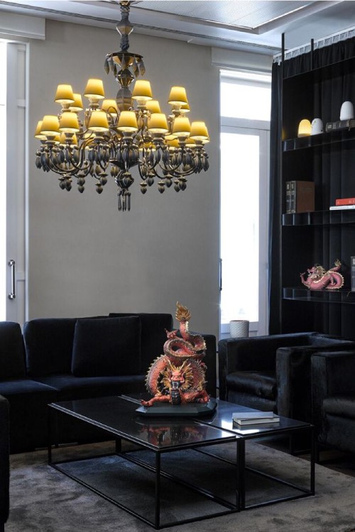 A Belle de Nuit 24 chandelier in black hangs over a coffee table with a Lladro figurine of a Chinese dragon on it. Some Dome portable table lamps sit on a shelf off to one side.