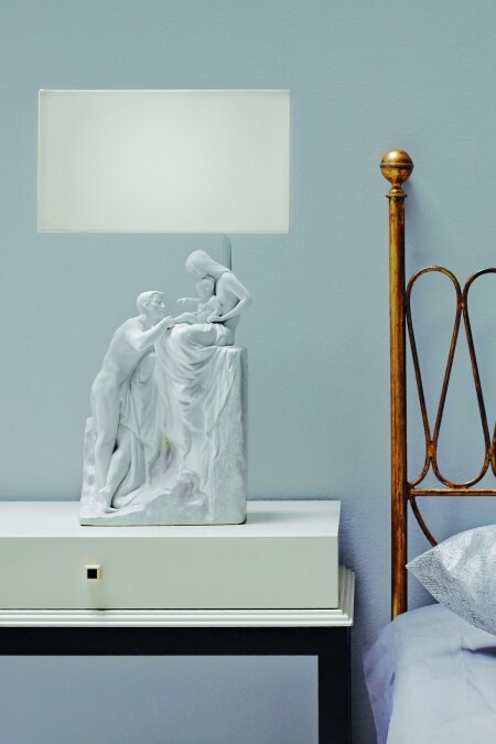 Family table lamp from Lladro sits on a bedside nightstand.