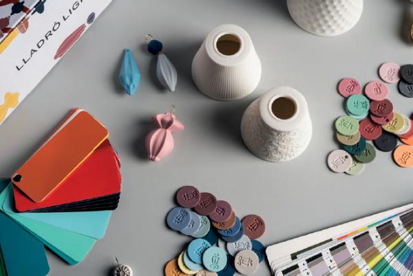 A Lladro workbench with a selection of swatches, bits, and pieces, including several parts of an Ivy & Seed chandelier.