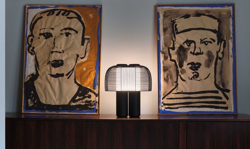 Studio BrichetZeigler's Yasuke table light for DCWéditions sits on a credenza between two paintings.