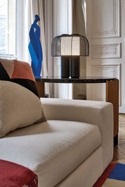 DCWéditions' Yasuke table light by Studio BrichetZiegler shines warmly (thanks to its integrated colour temperature control) from a living room side table.