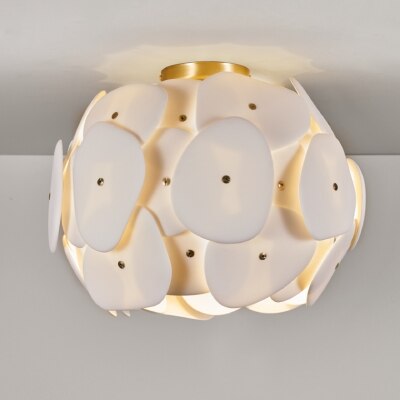 A close-up of Original BTC's Pebble ceiling light, with the light filtering out between and through the bone china plates.