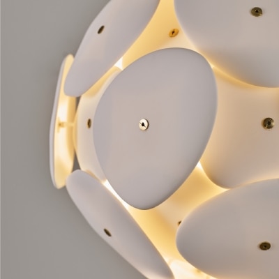 A detail shot of the light of Original BTC's Pebble suspension light as it filters through the bone china plates.