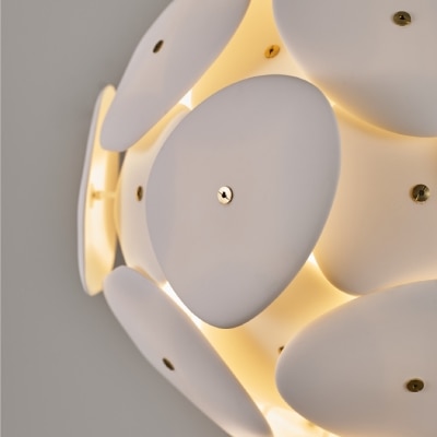 A detail shot of the light of Original BTC's Pebble suspension light as it filters through the bone china plates.