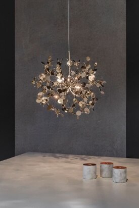 Argent Single Element pendant light in the new champagne finish hangs over a marbled table.