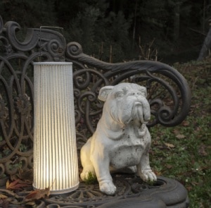 Hipatia outdoor floor light from a by arturo alvarez placed on a metal bench next to a concrete puppy