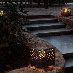 AMS outdoor floor light from B.lux illuminates stairs in a backyard terrace.