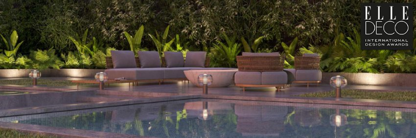 A luxurious poolside patio lined with Brokis' Bonbori outdoor floor lights.