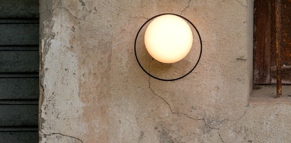 Circ A-3722X outdoor wall sconce illuminating the exterior of a weathered structure