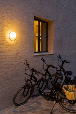 Circ A-3722X-W outdoor wall sconce lights a line of bicycles.