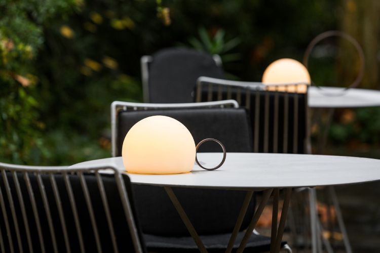 Circ portable outdoor table lights from Estiluz illuminate outdoor café tables