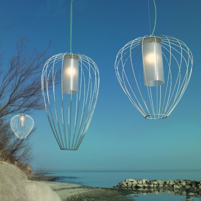 The range of Cell outdoor pendant lights hanging along a shoreline.