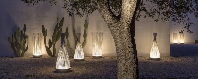 A selection of Don't Touch outdoor floor lights, some bundled with the included silicone O-ring and some loose, among cacti outdoors.