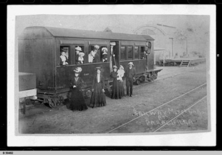 A vintage photograph of passengers in and around a railway passenger car in Parachilna.