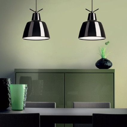 A pair of Clochef suspension lights, designed for Leucos by Massimo Iosa Ghini, hang over a dining room table.