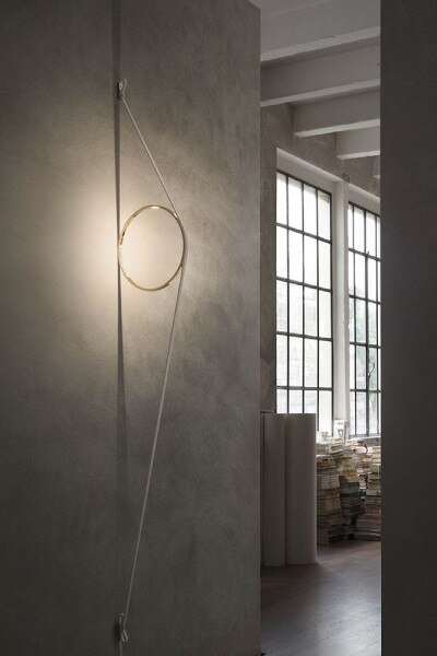 Formafantasma's WireRing from Flos, installed and illuminating the hallway of a condo