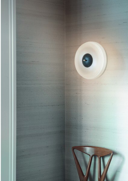 Trave wall light from Bert Frank makes a simple, elegant presence in an apartment hallway.