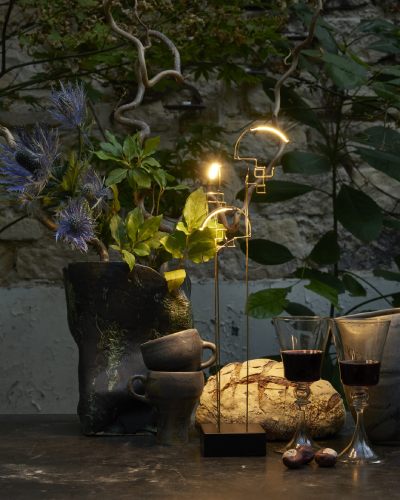 Boucle portable table light from DCWeditions surrounded by food and drink on a charmingly rustic garden table.