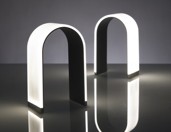 A pair of Mr. n table lights from Koncept show off the intriguing power of their unique forms.