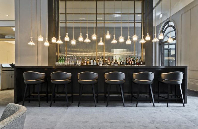 A line of Lee Broom's Decanterlight suspension lights illuminate a hotel bar in Sao Paulo, Brazil.