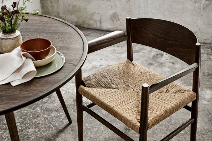 Mater's Nestor chair next to a small table on a rustic terrace. Note: Not a light.