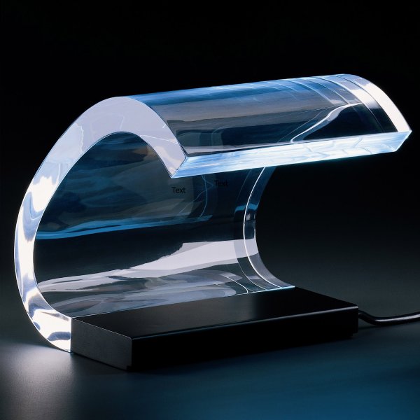 Acrilica table light from Oluce, illuminated in a darkened space.