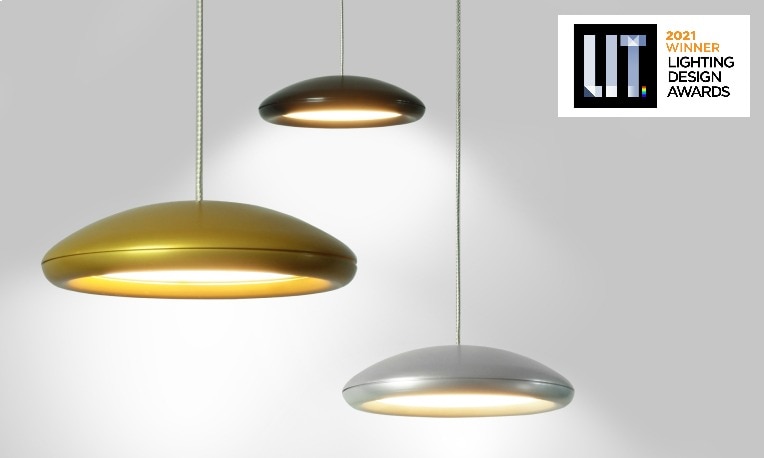 Three Ovolo pendants, designed by Saleem Khattak for his own company Archilume, in various size and finish combinations shine their light on a studio set. The LIT Awards badge appears in the upper right corner.