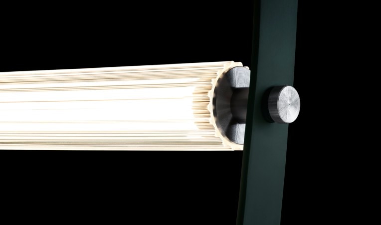 A close-up of the connection point between the broad, flat wire of WireLine chandelier and the ridged glass diffuser over the LED lamping.