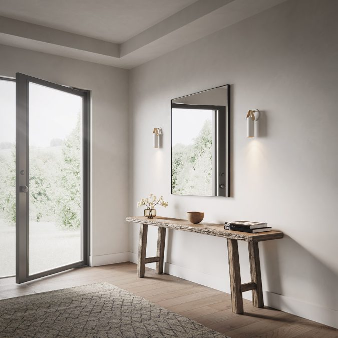 A pair of Spero S wall lights flank a side table in a hall leading to a patio door.