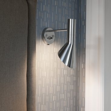 AJ wall sconce casts its light downwards next to an acoustic panel in a hospitality project.