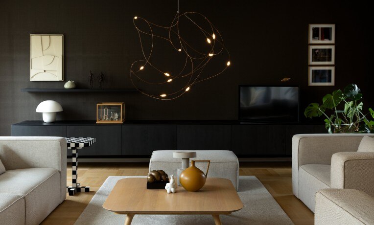 Studio Toer's Flock of Light 11 cluster suspension light hangs in a chic contemporary living room.