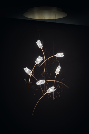 A moody studio image of Tulip 7 Round cluster suspension light, designed by Marc Sadler for Slamp.