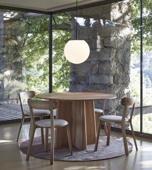 Sfera pendant light hangs above a wooden table in a dining nook.