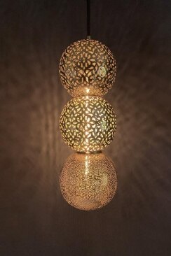 Dounia Homes' Riad suspension light shows off the effect its three differently-patterned shades project on walls in a dark space.