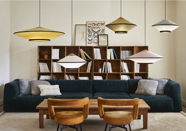 A Scandinavian-style living room with a variety of Jette Scheib's Cymbal pendant lights from Forestier in several size and finish combinations.