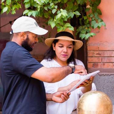 Dounia Tamri-Loeper discusses Nur pendant light with one of her production collaborators.