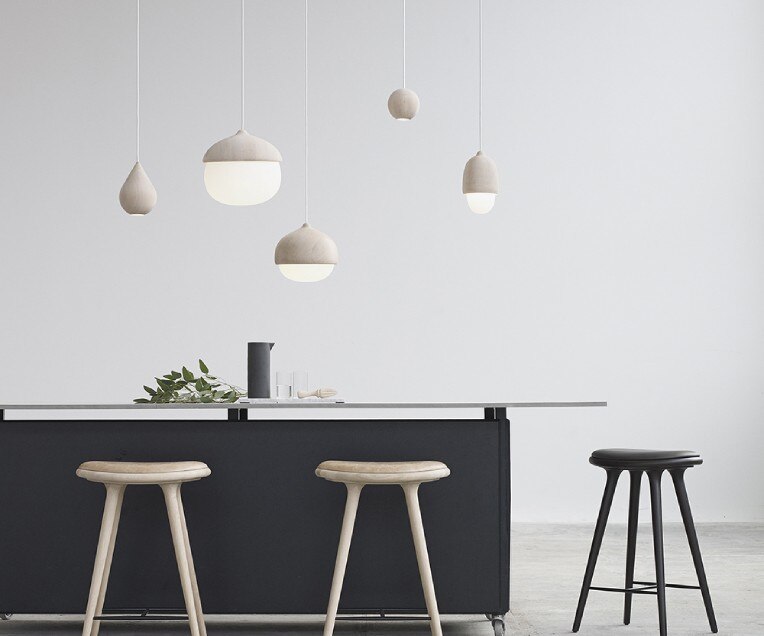 The Liuku and Terho collections of pendants hang above a kitchen island in a studio space