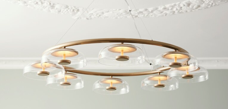 Nuura creative director Sofie Refer's Blossi 8 chandelier, seen from below against a white ceiling with Rococo accents