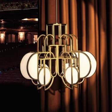 Moonrise Chandelier 2 suspension light illuminates a curtain in a darkened theatre.