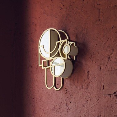 Lara Bohinc's Moonrise wall sconce 2 in gold, on the wall of Bohinc's London flat.