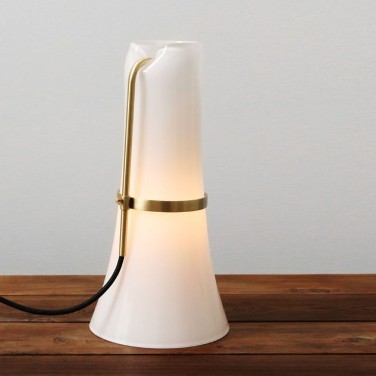 Push table lamp on a wooden credenza.