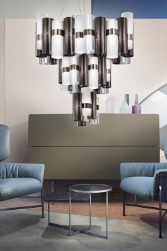 Lorenza Bozzoli's La Lollo XL chandelier for Slamp in pewter hangs between two chairs in a living room.